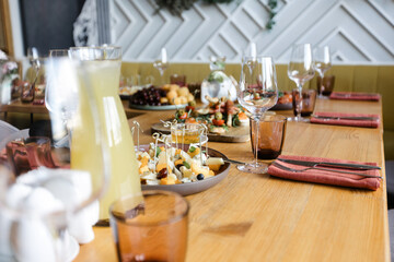 a set table in a cafe. plates with snacks. warm interior. holiday concept.
