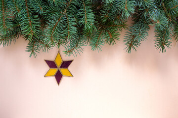 Christmas background with fir tree branches and Christmas star. Top view, close up