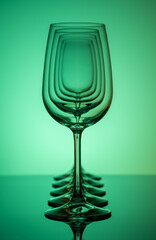 Five wine glasses silhouette in row concentric on green background