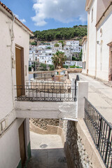 streets in Murtas at different levels with walkway access, flowerpots and white houses in the background perched on the mountain