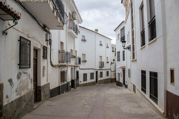 Fototapeta na wymiar street of tall white houses in Ugíjar