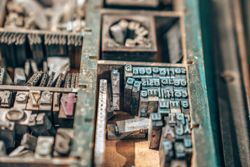 Old typography printing machine with letter samples. Mechanical printing process.