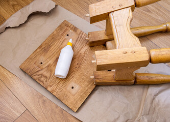 White glue for bonding a broken stool. Home furniture repair.