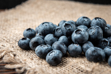 Blueberry on dark wooden background.