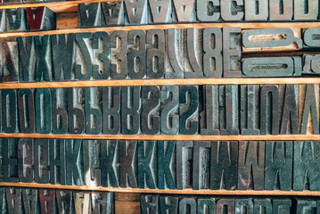 Old typography printing machine with letter samples. Mechanical printing process.