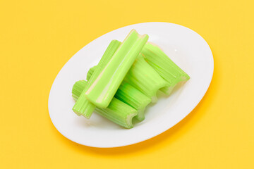 Fresh Chopped Celery Sticks on White Dish. Vegan and Vegetarian Culture. Raw Food. Healthy Diet with Negative Calorie Content