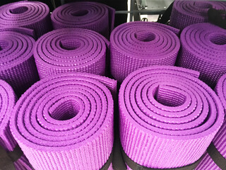 Close up purple yoga mat rolls