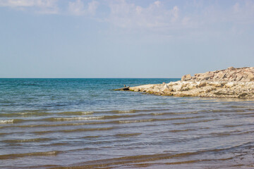 Morning scenery lakeside scenery: coastline, summer sky and waving water of the lake