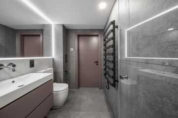 Modern minimalist bathroom interior design with grey stone tiles