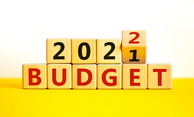 Planning 2022 budget new year symbol. Turned a wooden cube and changed words 'Budget 2021' to 'Budget 2022'. Beautiful white background, copy space. Business, 2022 budget new year concept.