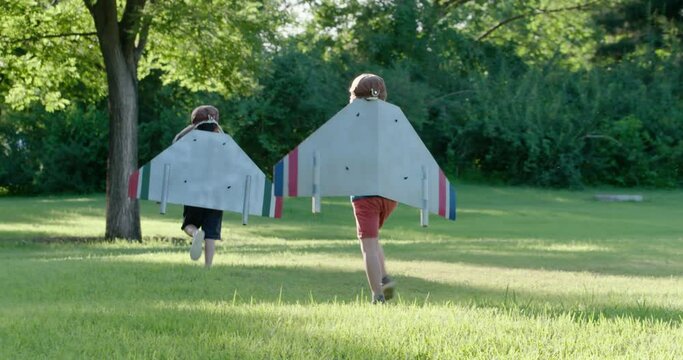 Little boys in costume playing on meadow,4K
