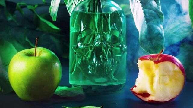 short video edited from two photos in the form of gif two green and red apples and tree branches in a vase in the shape of a human skull red apple are being bitten