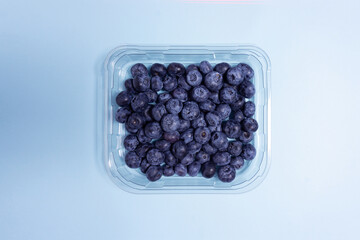 Creative food health diet concept photo of blueberry on blue background..