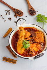 Indian Spiced Chicken Curry in a Kadai on White Background Directly Above Photo