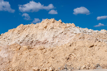 Pile of limestone against blue sky.