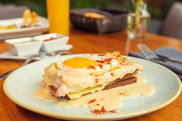 Two fried free range eggs on toast for breakfast with yellow yolks. Gourmet breakfast concept in restaurant Eggs in creamy sauce