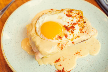 Two fried free range eggs on toast for breakfast with yellow yolks. Gourmet breakfast concept in restaurant Eggs in creamy sauce