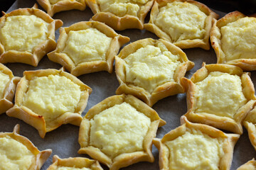 baked cheesecakes with cottage cheese on a baking sheet, aromatic homemade cakes