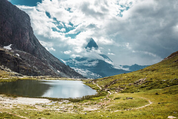 Matterhorn mountain in Swiss Alps. Clouds and lake in mountains. Zermatt, Switzerland.