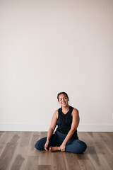 Fototapeta premium happy smiling woman practicing yoga relaxing in gym 