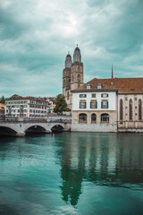 Fototapeta na wymiar Old town in Zurich city, Switzerland. Panorama of river and embankment with historic buildings. Pleasure boat. Swiss vacation.