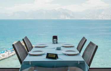 A table in a restaurant or a summer cafe on the sea coast of Antalya, Turkey. Place in a restaurant with a wonderful sea view.