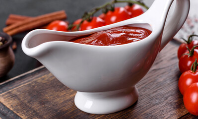 Red sauce or ketchup in a bowl and ingredients for cooking