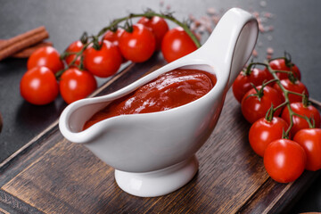 Red sauce or ketchup in a bowl and ingredients for cooking