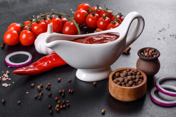 Red sauce or ketchup in a bowl and ingredients for cooking