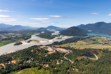 Fototapeta na wymiar Aerial View of Fraser Valley with Canadian Nature Mountain Landscape Background. Harrison Mills near Chilliwack, British Columbia, Canada.