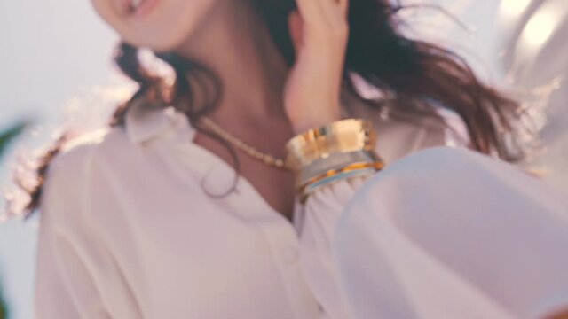 girl with jewelry on the background of the sunny sky