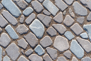 The texture of the paving stones made of natural granite, background.