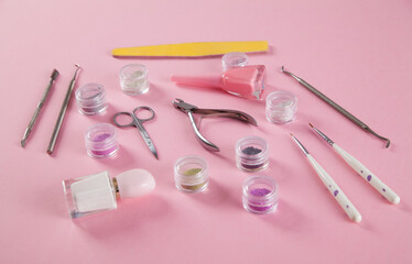 Manicure accessories on an isolated pink background.