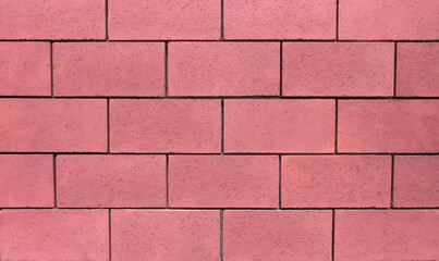 Wall of concrete blocks in pink, background
