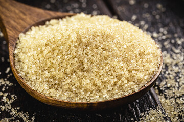 wooden spoon with pure sugar straight from sugar cane, organic product, natural cooking ingredient