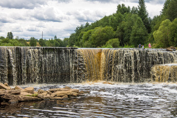 Beautiful Sablinsky waterfall on the Tosna River in the Leningrad region in Russia on a cloudy summer day and a space for copying