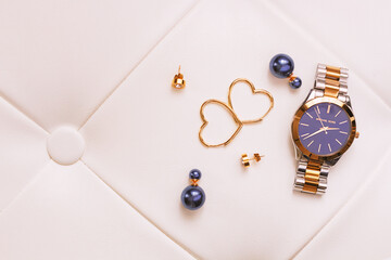 Female gold jewerly and watch complete the stylish look