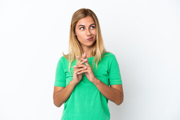Blonde Uruguayan girl isolated on white background scheming something