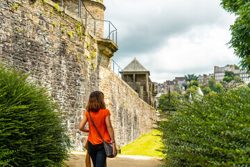 A young tourist visiting the castle of Fougeres. Brittany region, Ille et Vilaine department, France