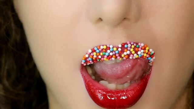 Closeup of a beautiful woman lips with beautiful colorful make up sending air kiss . Close up of girl's mouth having flirty emotions and sending air kiss .