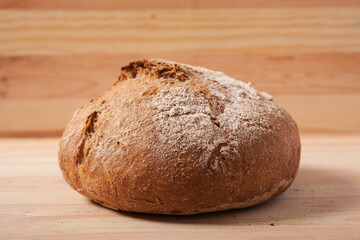 Handmade fresh wheat bread on wooden background in the morning light. horizontal close-up frame side view