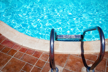 Beautifully stylish staircase steps in a swimming pool on nature sea background