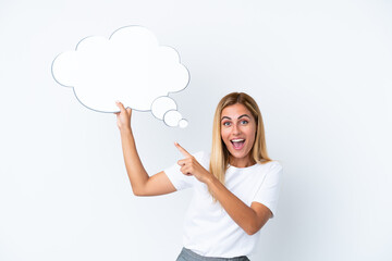 Blonde Uruguayan girl isolated on white background holding a thinking speech bubble with surprised expression