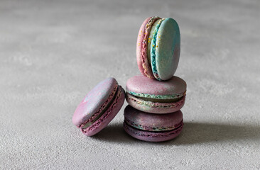 Fototapeta na wymiar Colorful French macaroons with dor blue cheese on a light gray background. Horizontal format