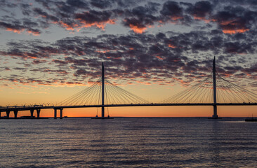 View of the cable-stayed bridge and the bay at sunset