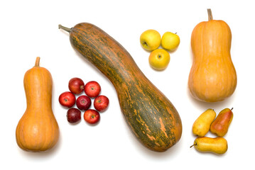 Top view of three different ripe pumpkins, red and yellow apples and pears, isolated on a white background. Autumn harvest.