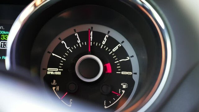 The car pics up speed, the load on the engine, tachometer arrow is going up. High RPM in an American muscle car. Classical view.
