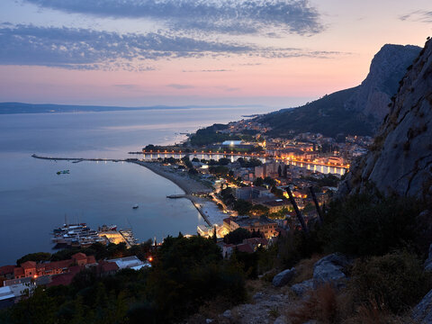 City of Omis by night. Evening panorama of the Croatian seaside resort. Blue hour.