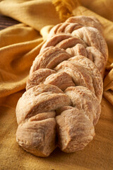 braided homemade bread on tablecloth