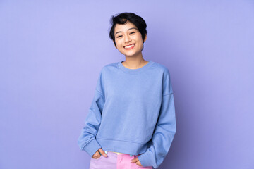 Young Vietnamese woman with short hair over isolated purple background laughing